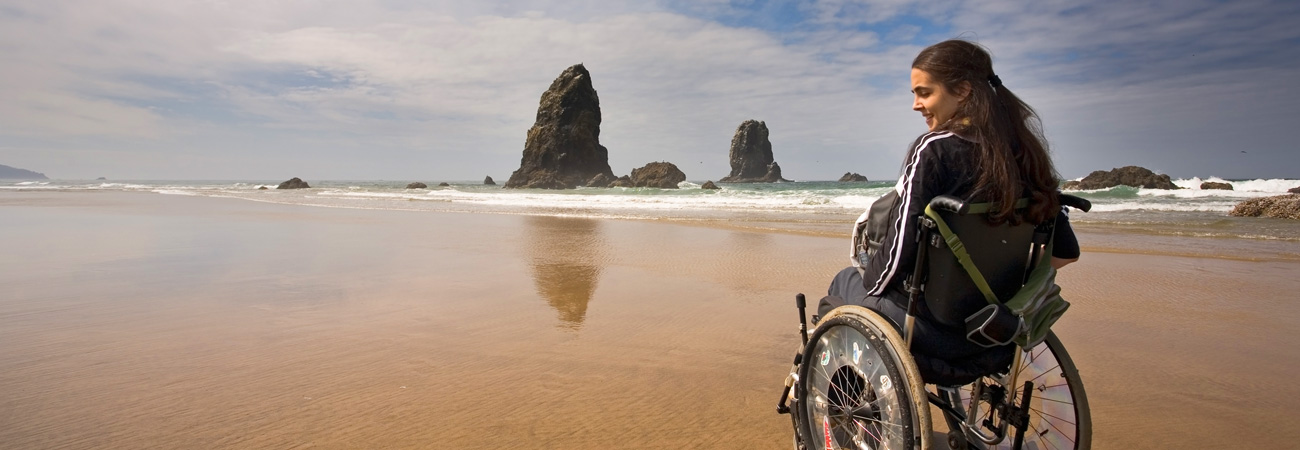 Girl in wheelchair on the beach